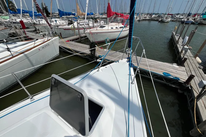 Slide: The Image of Sailboats docked at marina, featuring a 2000 Catalina 320 in the foreground. - 6