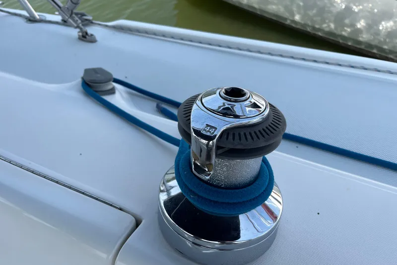 Slide: The Image of Winch on a 2000 Catalina 320 sailboat deck with blue rope. - 8