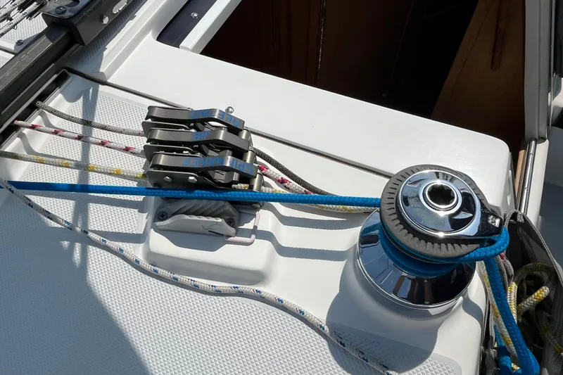 Slide: The Image of Sailing equipment on a 2000 Catalina 320 yacht, featuring winch and rope clutches. - 9
