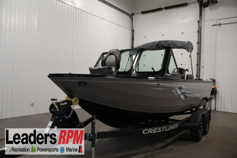 The Image of 2026 Crestliner 1850 Commander boat on trailer in indoor showroom. - 0