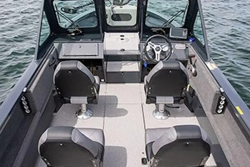 Slide: The Image of Interior of 2026 Crestliner 1850 Commander boat with seating and steering wheel on water. - 12