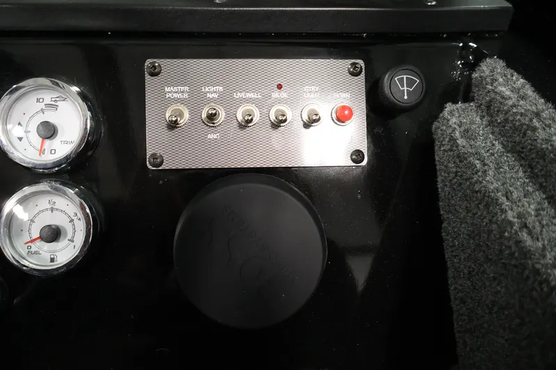 Slide: The Image of Dashboard controls of 2026 Crestliner 1850 Commander boat with gauges and switches. - 21