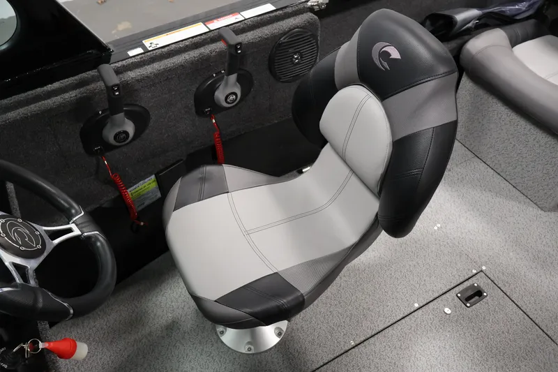 Slide: The Image of 2026 Crestliner 1850 Commander boat interior with sleek, modern seating and steering wheel. - 24