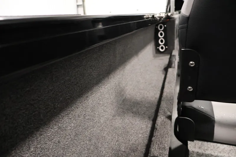 Slide: The Image of Interior view of 2026 Crestliner 1850 Commander boat, featuring seating and side panel details. - 32