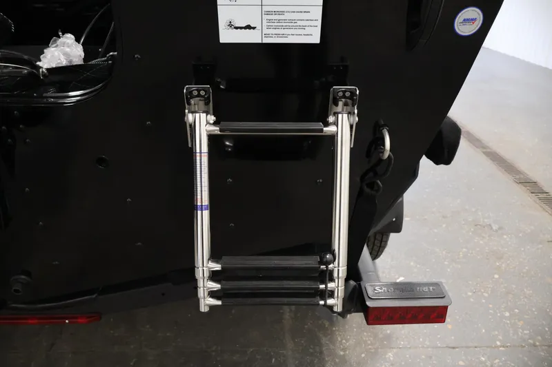 Slide: The Image of Rear view of 2026 Crestliner 1850 Commander boat with foldable ladder. - 33