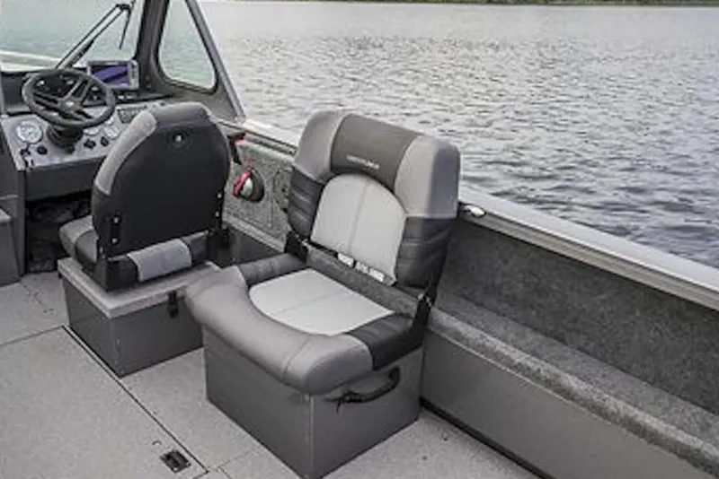 Slide: The Image of 2026 Crestliner 1850 Commander boat interior with gray seating and steering console. - 4