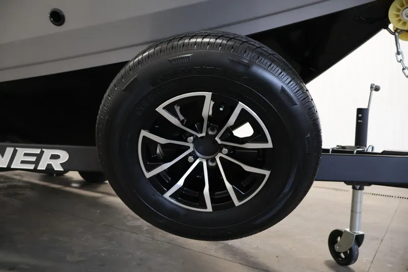 Slide: The Image of 2026 Crestliner 1850 Commander trailer wheel with sleek black and silver design. - 40