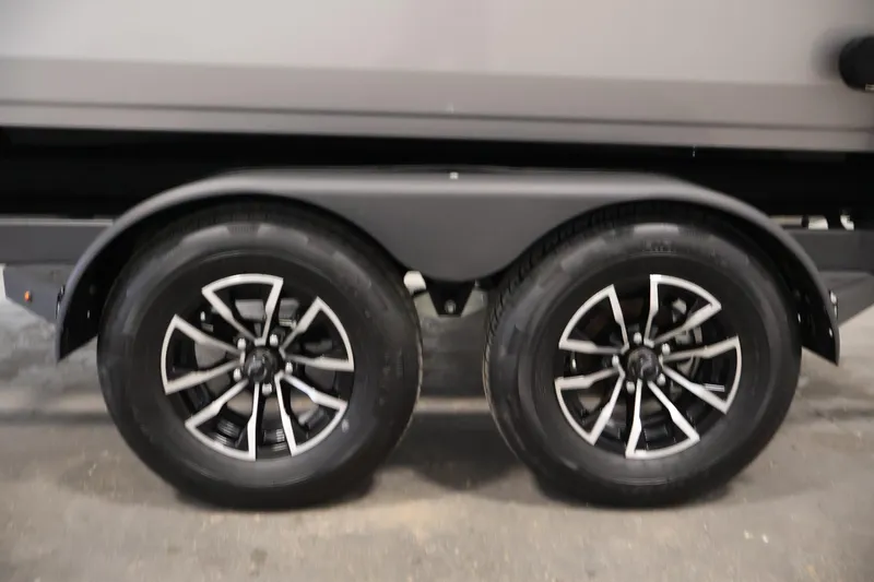 Slide: The Image of Trailer wheels of 2026 Crestliner 1850 Commander boat, featuring sleek black rims. - 42