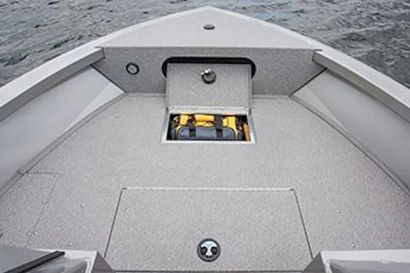 Slide: The Image of 2026 Crestliner 1850 Commander boat interior with storage compartment, on water. - 7