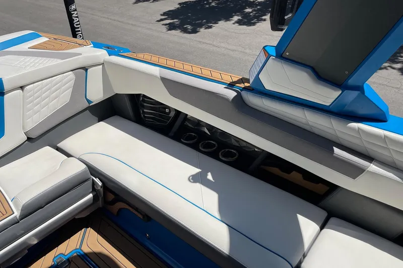 Slide: The Image of 2022 Nautique Super Air Nautique G25 interior with white and blue seating. - 11