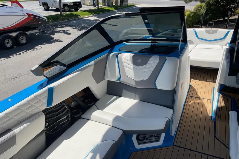 Slide: The Image of 2022 Nautique Super Air Nautique G25 interior with white and blue seating. - 12