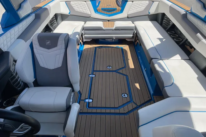 Slide: The Image of 2022 Nautique Super Air Nautique G25 interior with luxurious seating and sleek design. - 14