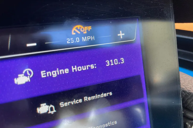 Slide: The Image of Dashboard display of a 2022 Nautique Super Air Nautique G25 showing 310.3 engine hours. - 15