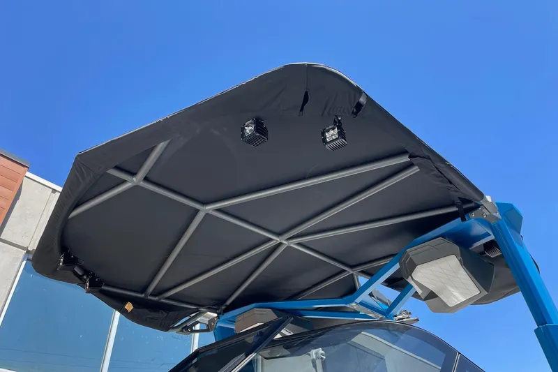 Slide: The Image of 2022 Nautique Super Air Nautique G25 boat canopy against clear blue sky. - 3