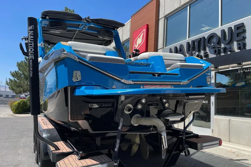Slide: The Image of 2022 Nautique Super Air Nautique G25 boat displayed at dealership, rear view. - 4
