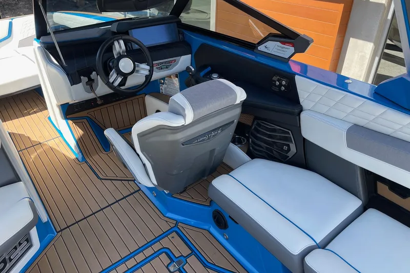 Slide: The Image of 2022 Nautique Super Air Nautique G25 interior with modern helm and luxurious seating. - 8