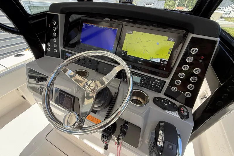 Slide: The Image of 2022 Robalo 266 Cayman boat dashboard with advanced navigation and control systems. - 10