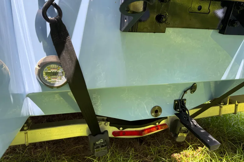 Slide: The Image of 2022 Robalo 266 Cayman boat stern with trailer and securing straps. - 3