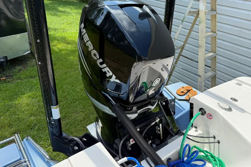 Slide: The Image of 2022 Robalo 266 Cayman boat with Mercury outboard engine, docked outdoors. - 4