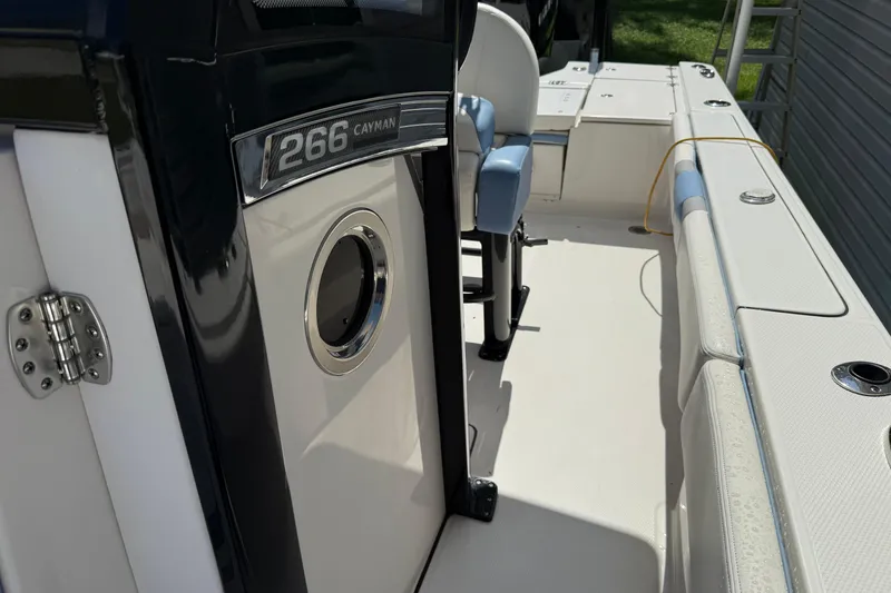 Slide: The Image of 2022 Robalo 266 Cayman boat interior, featuring seating and sleek design elements. - 7