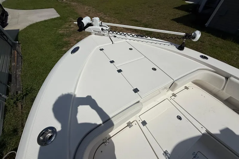 Slide: The Image of 2022 Robalo 266 Cayman boat deck with storage compartments and trolling motor. - 8