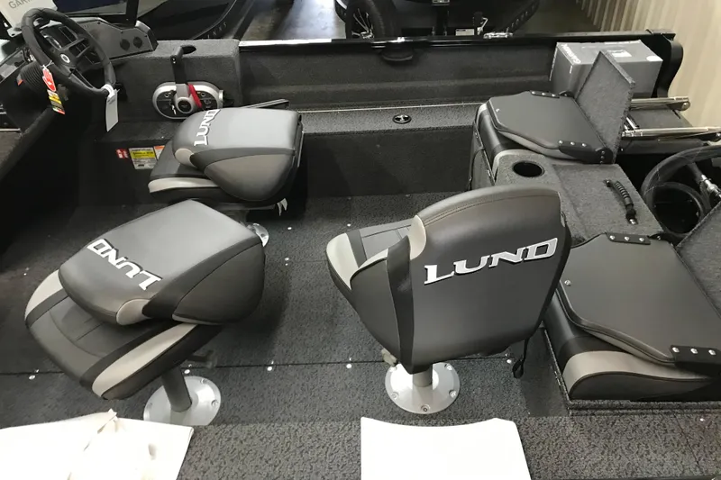 Slide: The Image of Interior of 2026 Lund 1650 Rebel XL Sport boat with branded seating and steering console. - 14