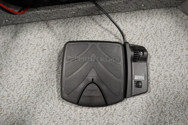 Slide: The Image of Minn Kota foot pedal on 2026 Crestliner 1650 Kodiac SC boat carpet. - 13