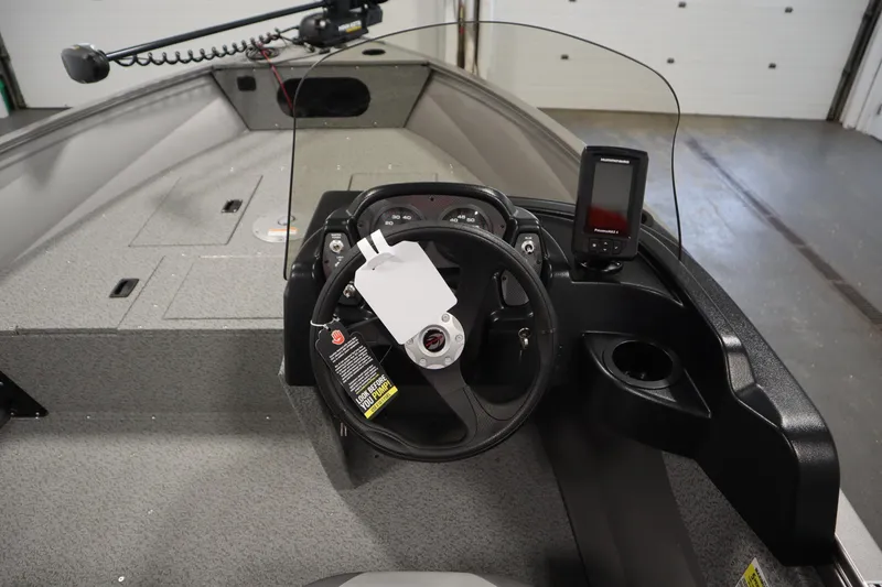 Slide: The Image of 2026 Crestliner 1650 Kodiac SC boat interior with steering wheel and control panel. - 20