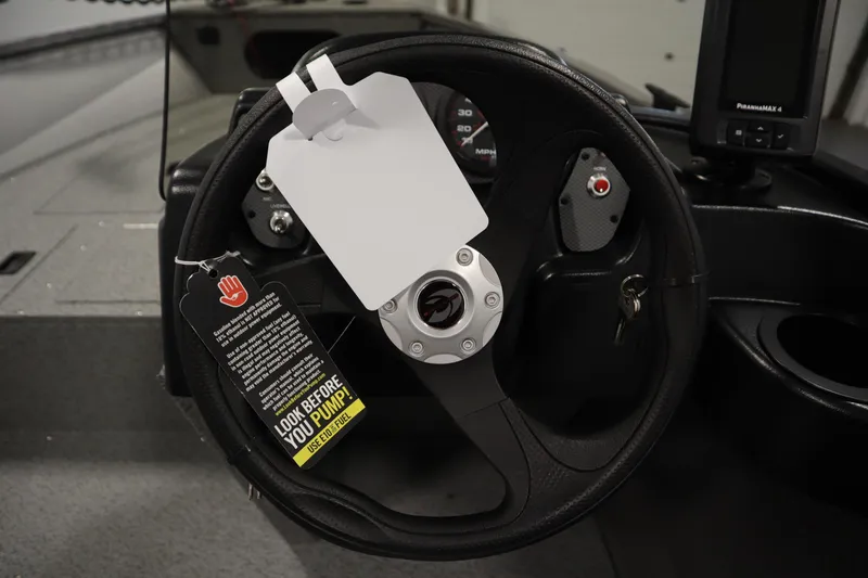 Slide: The Image of Steering wheel of 2026 Crestliner 1650 Kodiac SC boat with safety tags attached. - 21