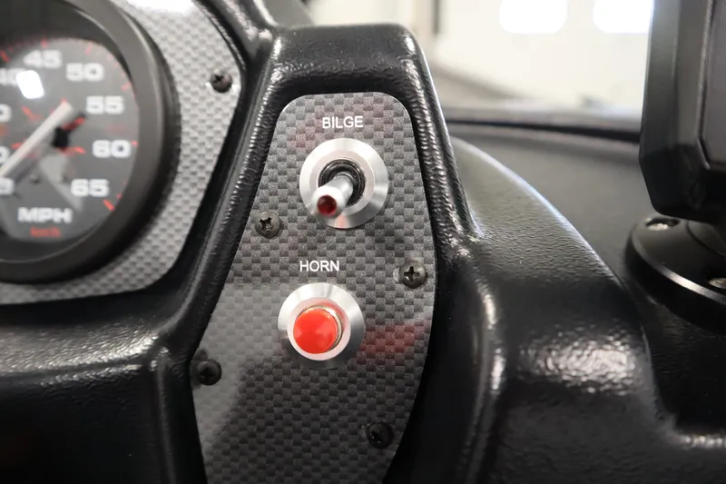 Slide: The Image of Dashboard controls of 2026 Crestliner 1650 Kodiac SC boat, featuring bilge and horn switches. - 25