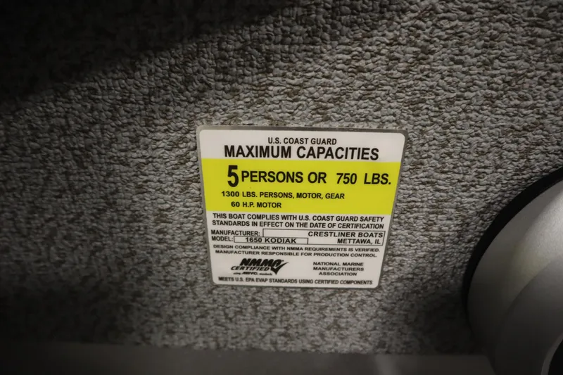 Slide: The Image of 2026 Crestliner 1650 Kodiac SC capacity label, 5 persons or 750 lbs, U.S. Coast Guard compliant. - 27
