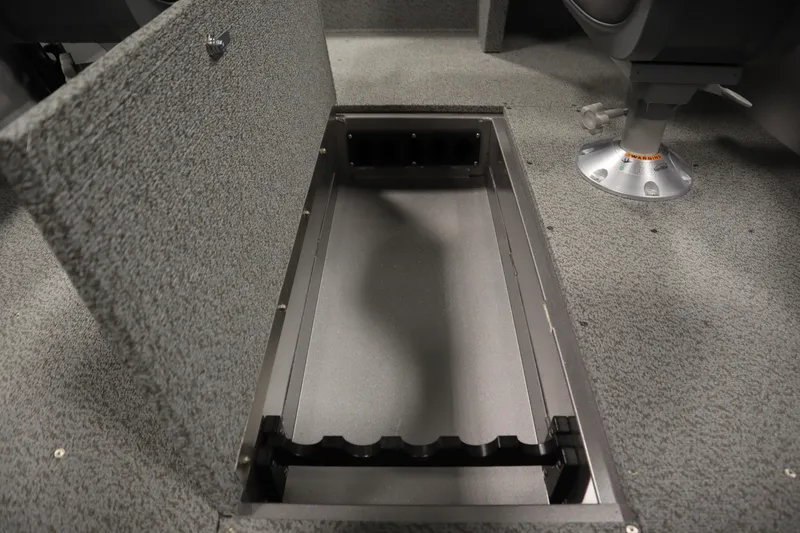 Slide: The Image of 2026 Crestliner 1650 Kodiac SC boat interior storage compartment, open and empty. - 32