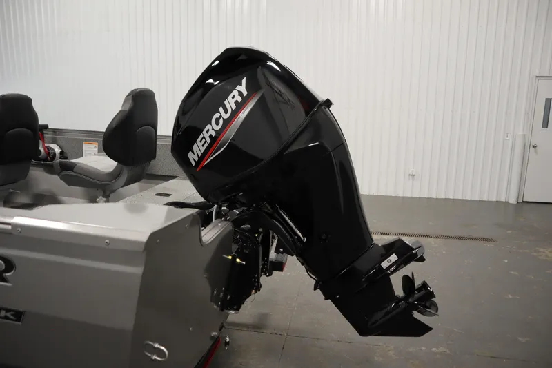 Slide: The Image of 2026 Crestliner 1650 Kodiac SC boat with Mercury outboard motor in a showroom. - 37