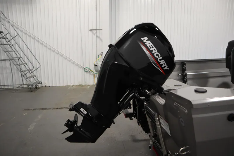 Slide: The Image of 2026 Crestliner 1650 Kodiac SC with Mercury outboard motor in a garage setting. - 38