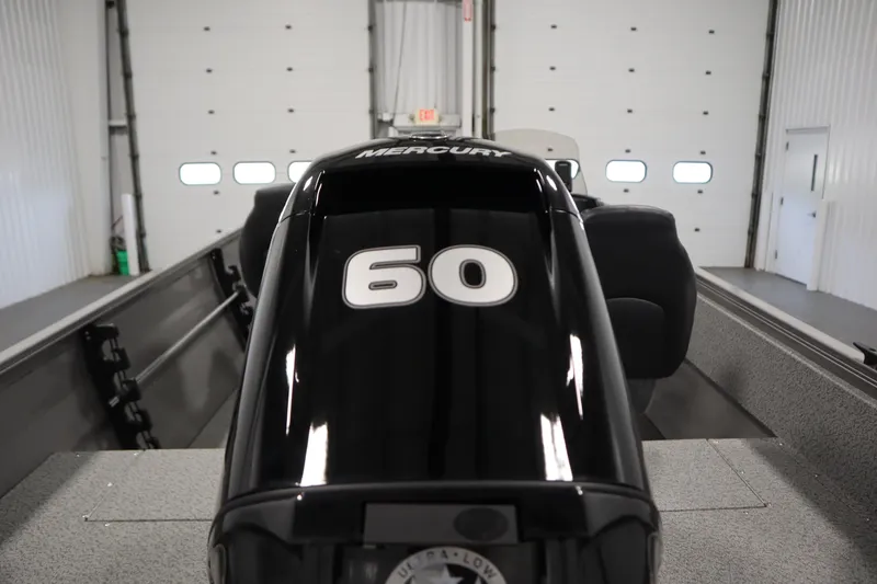 Slide: The Image of 2026 Crestliner 1650 Kodiac SC boat with Mercury 60 horsepower engine in a garage. - 39