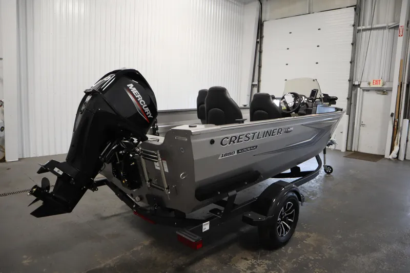 Slide: The Image of 2026 Crestliner 1650 Kodiac SC boat with Mercury engine in a garage setting. - 4