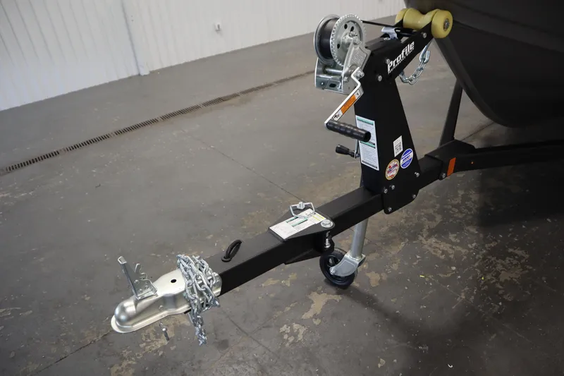 Slide: The Image of 2026 Crestliner 1650 Kodiac SC trailer hitch with chains and winch in a garage. - 41