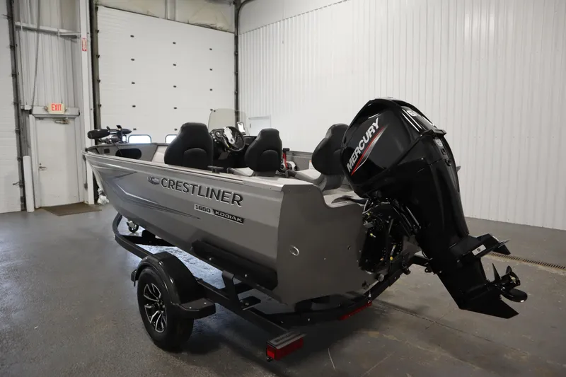Slide: The Image of 2026 Crestliner 1650 Kodiac SC boat with Mercury engine in a garage setting. - 6