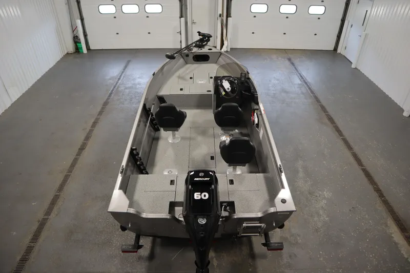 Slide: The Image of 2026 Crestliner 1650 Kodiac SC boat in a garage, featuring a 60 HP Mercury engine. - 9