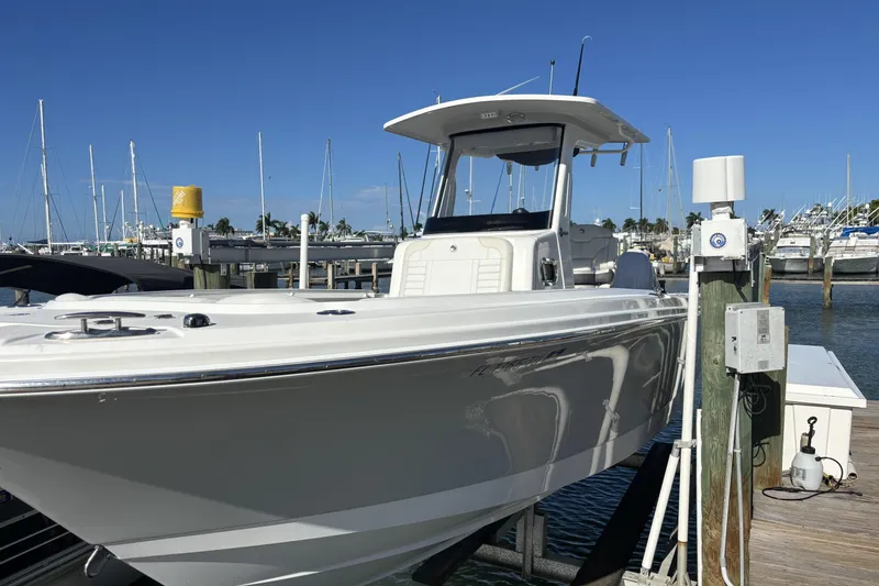 The Image of 2024 Edgewater 262CC boat docked at marina under clear blue sky. - 0