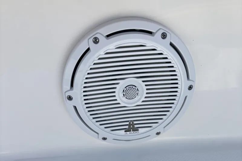 Slide: The Image of White JL Audio speaker on 2024 Edgewater 262CC boat. - 13
