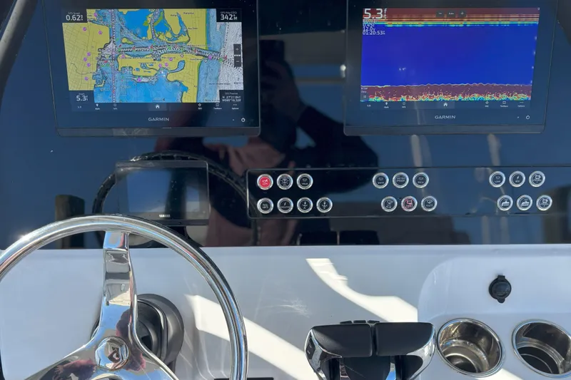 Slide: The Image of 2024 Edgewater 262CC dashboard with Garmin navigation and sonar displays. - 14