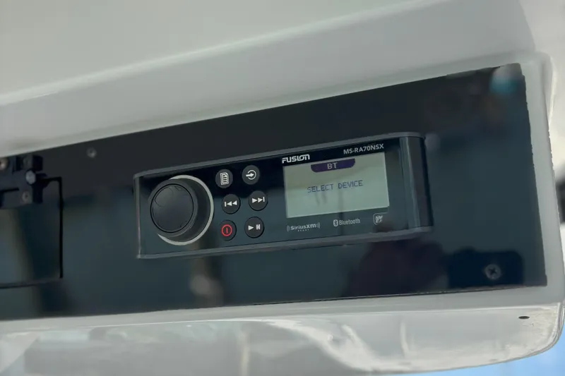 Slide: The Image of Fusion MS-RA70NSX stereo system on 2024 Edgewater 262CC boat dashboard. - 16