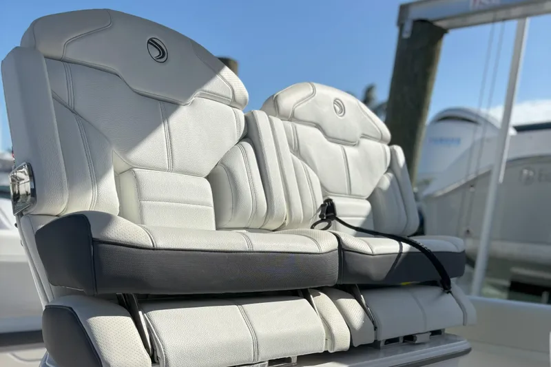 Slide: The Image of Luxurious seating on 2024 Edgewater 262CC boat, featuring premium white upholstery. - 17