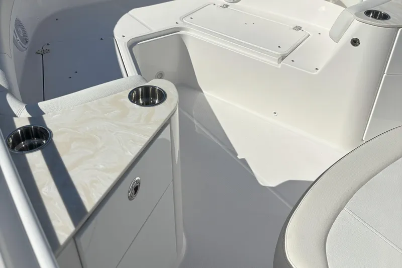 Slide: The Image of 2024 Edgewater 262CC boat interior with cup holders and seating area. - 18