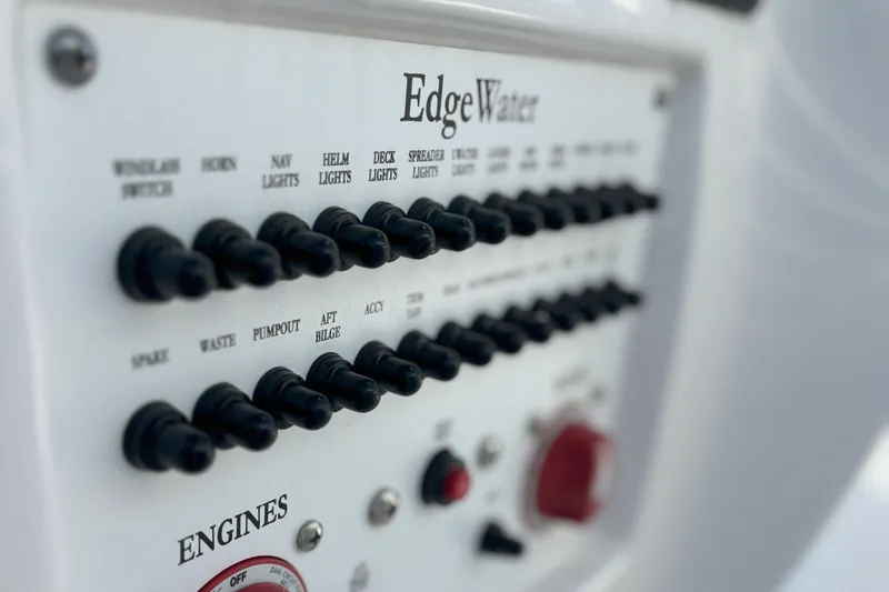 Slide: The Image of Control panel of 2024 Edgewater 262CC boat with labeled switches and dials. - 19