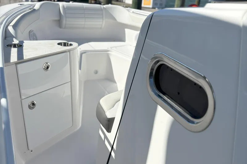 Slide: The Image of 2024 Edgewater 262CC boat interior with storage compartments and seating. - 22