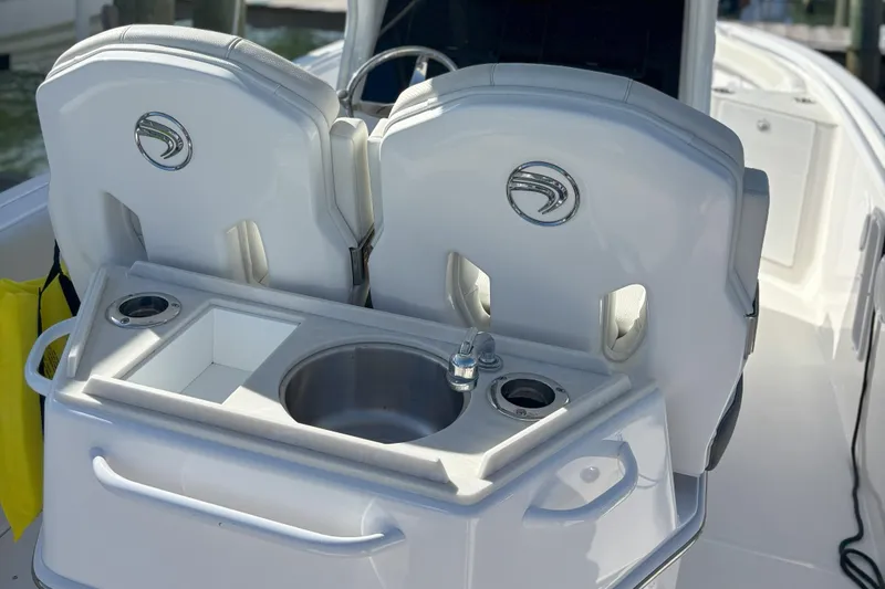 Slide: The Image of 2024 Edgewater 262CC boat interior with sink and seating area. - 3