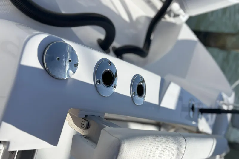 Slide: The Image of 2024 Edgewater 262CC boat detail showing rod holders and fittings. - 7
