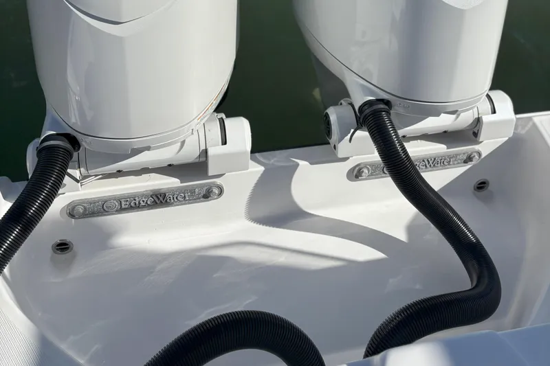 Slide: The Image of 2024 Edgewater 262CC boat engines with hoses, showcasing brand detail. - 8